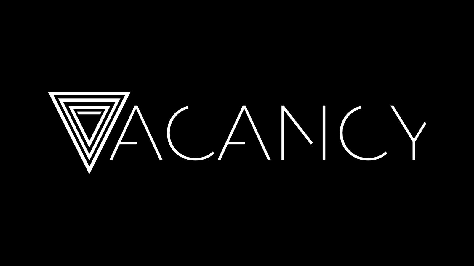 A logo reading "Vacancy" done in white on a black background, with the V replaced by an upside down triangle outline with several other triangle outlines inside of it.
